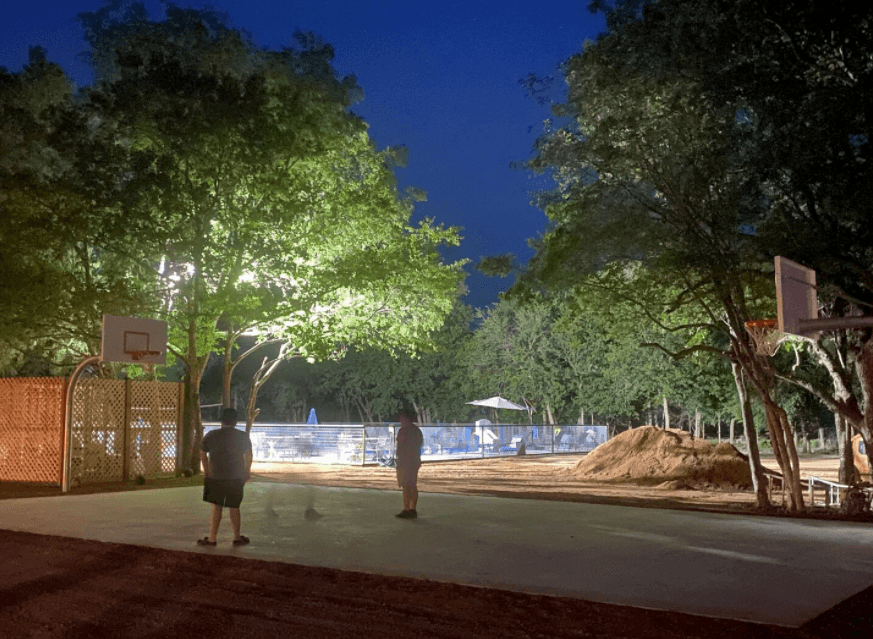 The basketball court is lit up at night!
