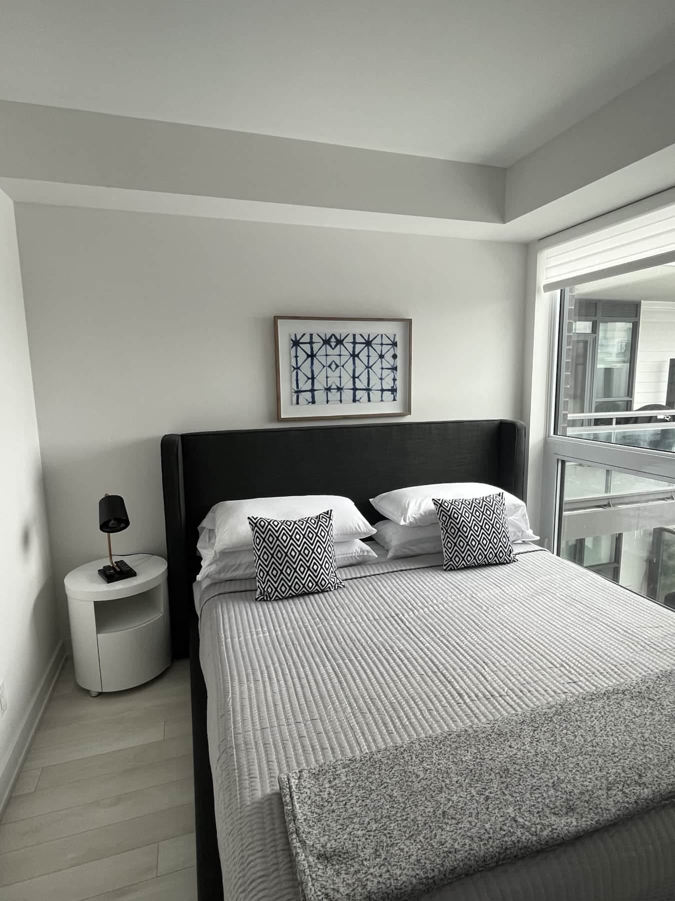 Guest Bedroom with a king size bed and a wall mounted tv
