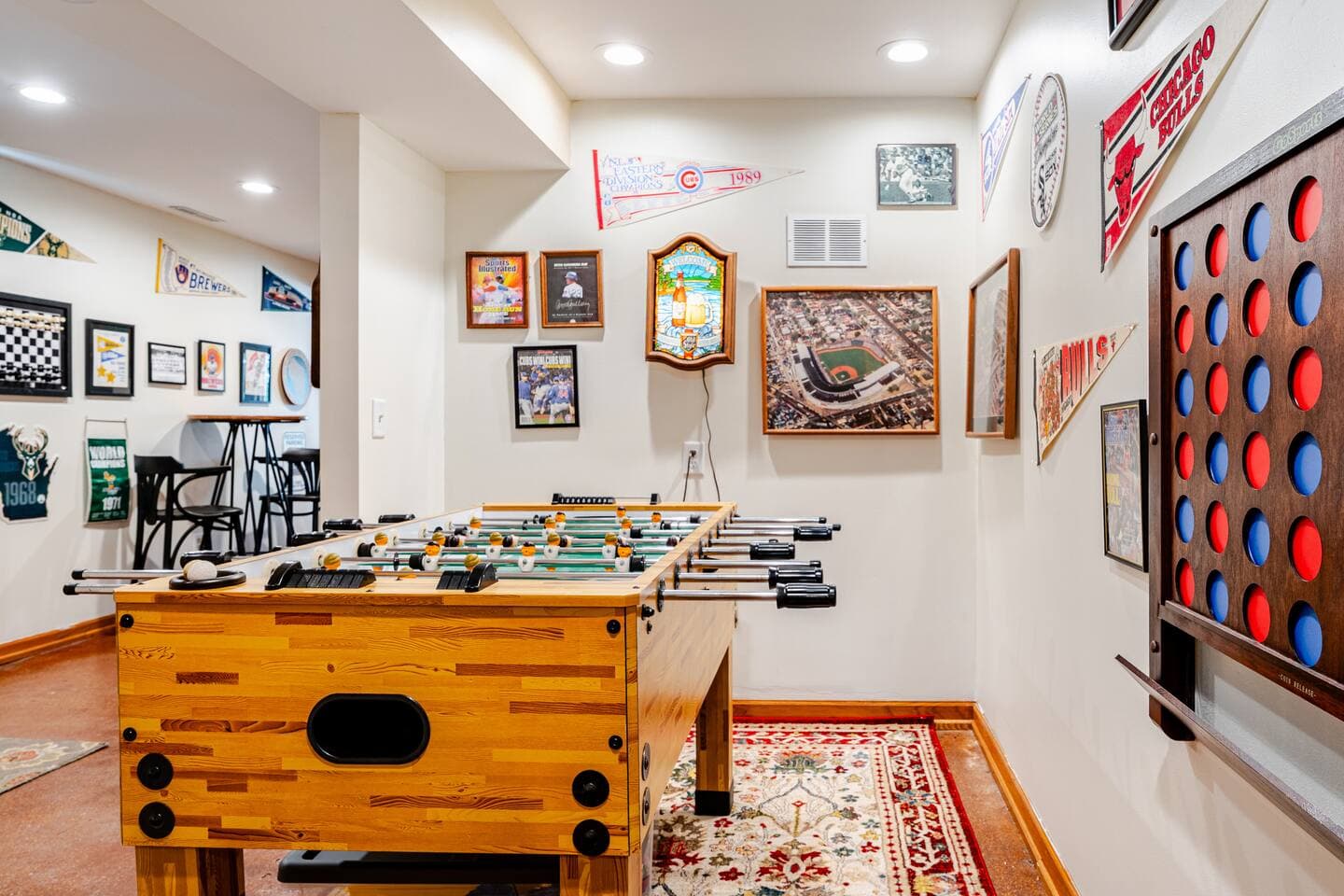 Foosball table, Connect 4 on wall, and Chicago sports meets Milwaukee sports theme offered in this photo of our gameroom.