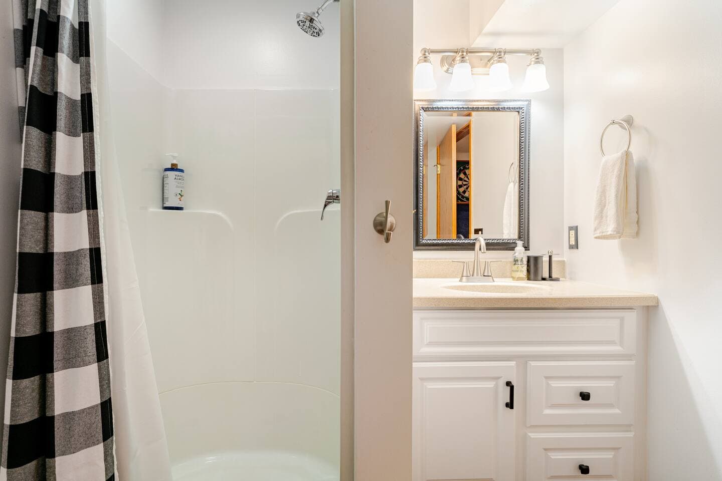 Full bath, in walkout basement off of the Game Room area, offers a standing shower, toilet, and vanity.