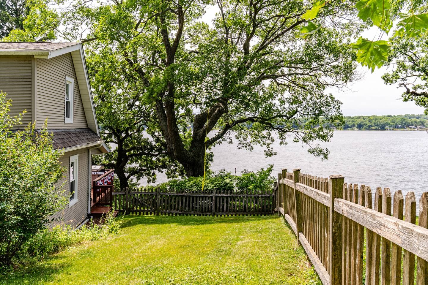 Sideyard is completely fenced for kids and pets, but, is on a hillside that offers nice views overlooking Bohner's Lake.