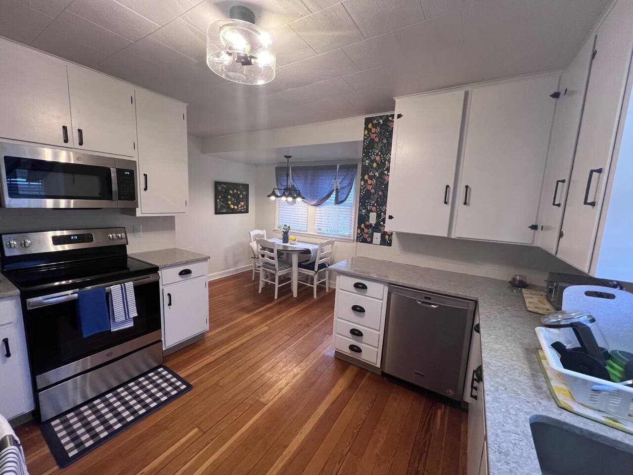 Dining room table hosts panels that flip up to host 2-4 people.