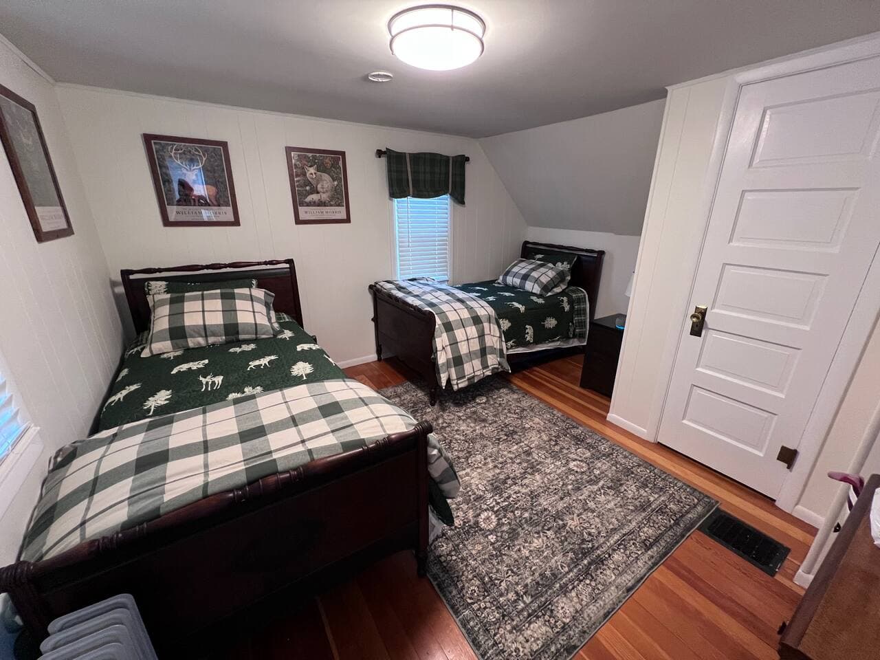 Two twin size beds complete with a closet and dresser.