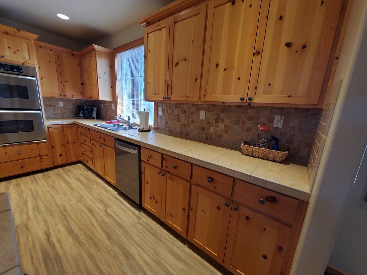Kitchen sink and dishwasher with view of the territory. Tons of counter space.