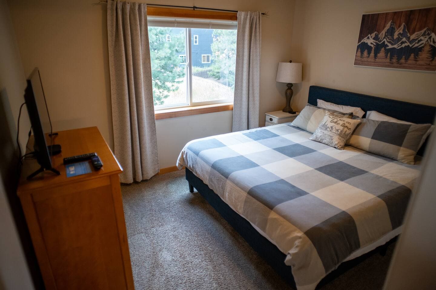 Upstairs king bed with taller dresser and closet space for hanging clothes or storing luggage.