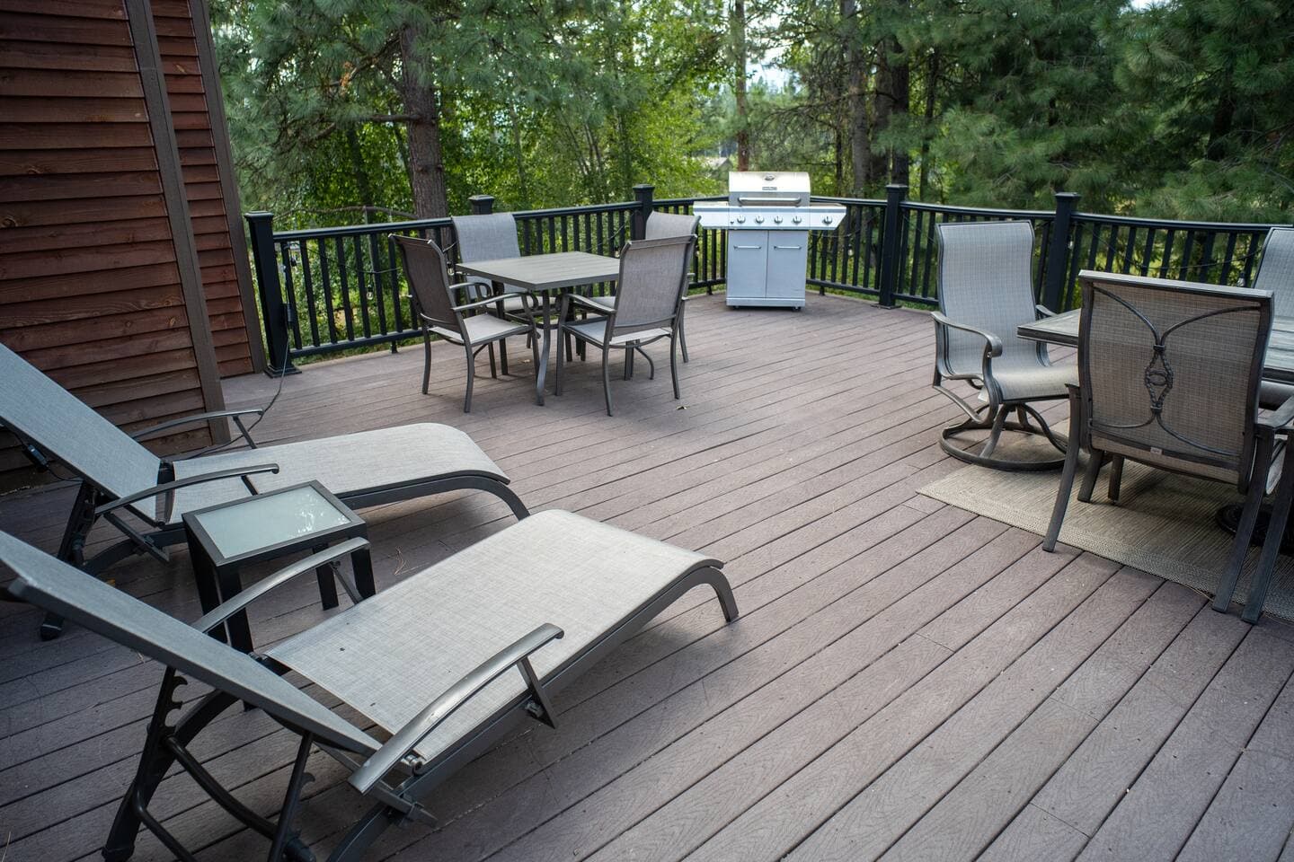 Large trex deck has ample seating for all guests, hot tub, and loungers.