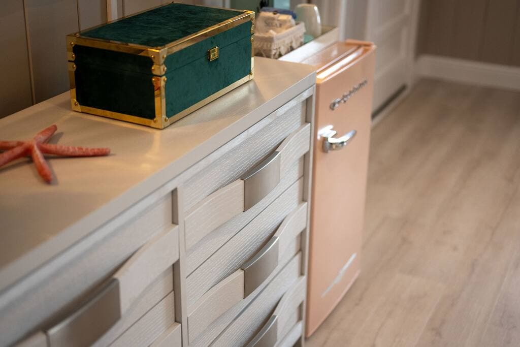 Close Up of Flamingo Studio Dresser, Snacks, Keurig, Fridge