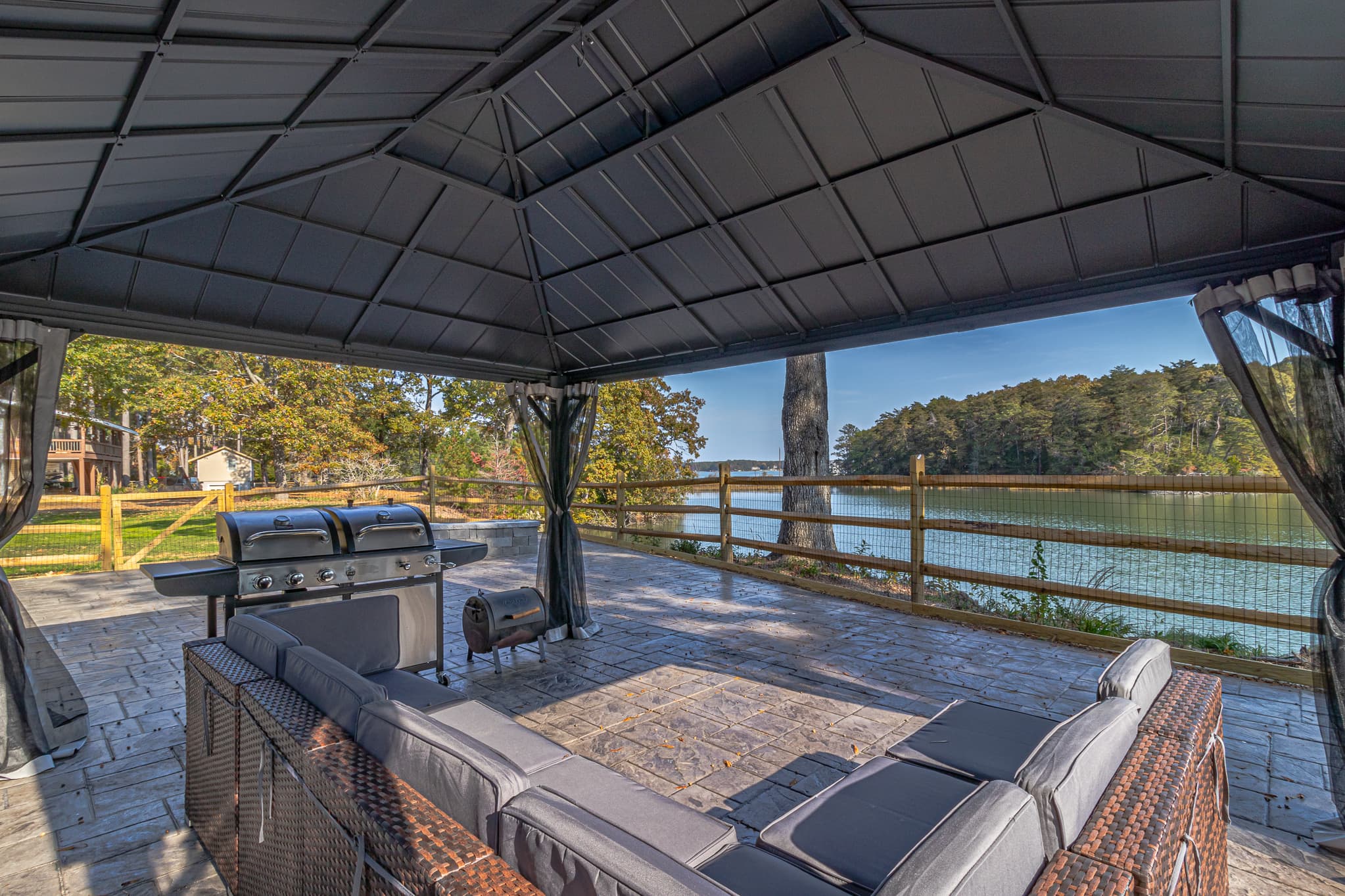 Sit under the covered gazebo w/ netting to keep bugs out. Dual fuel grill w/ separate charcoal grill