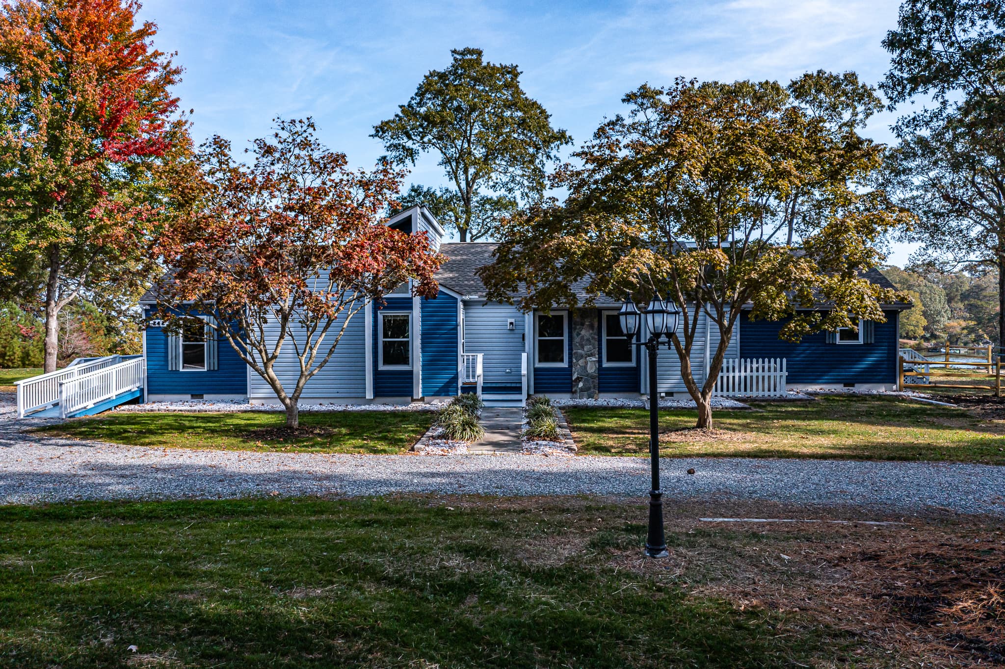 Front of Paws and Reflect. Spacious one-level home. Circular, gravel driveway.