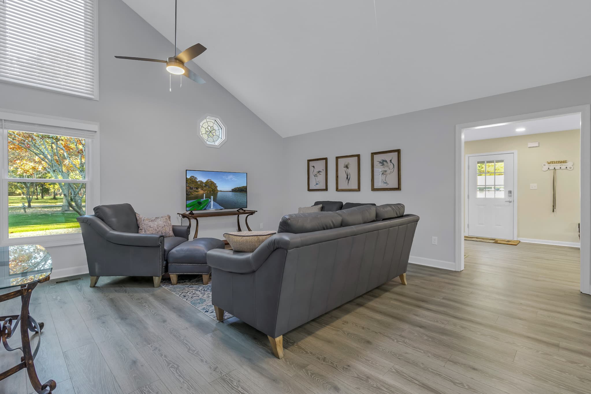 Vaulted ceiling and dual overhead fans in living room.