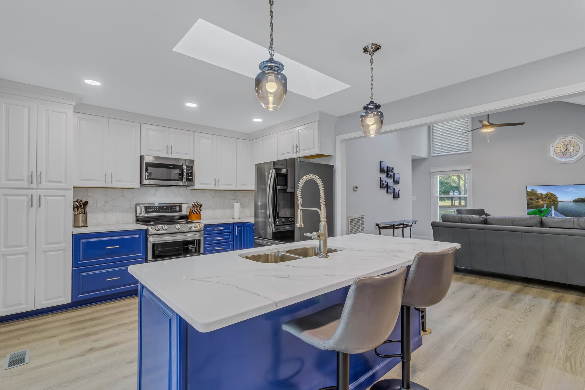 Kitchen island with seating. Double electric oven and cooktop.