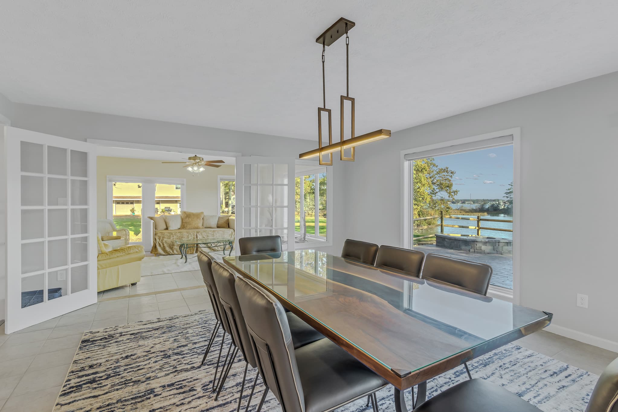 Large, custom dining table with water view and seating for 8.