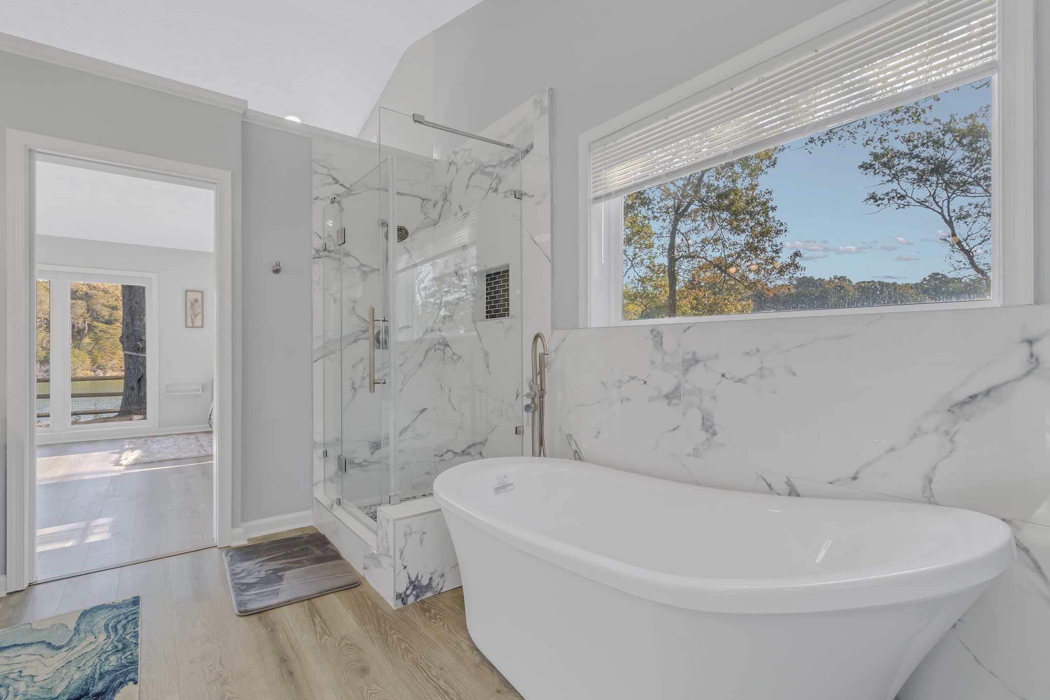 Soaking tub and beautiful blue pebbled shower.