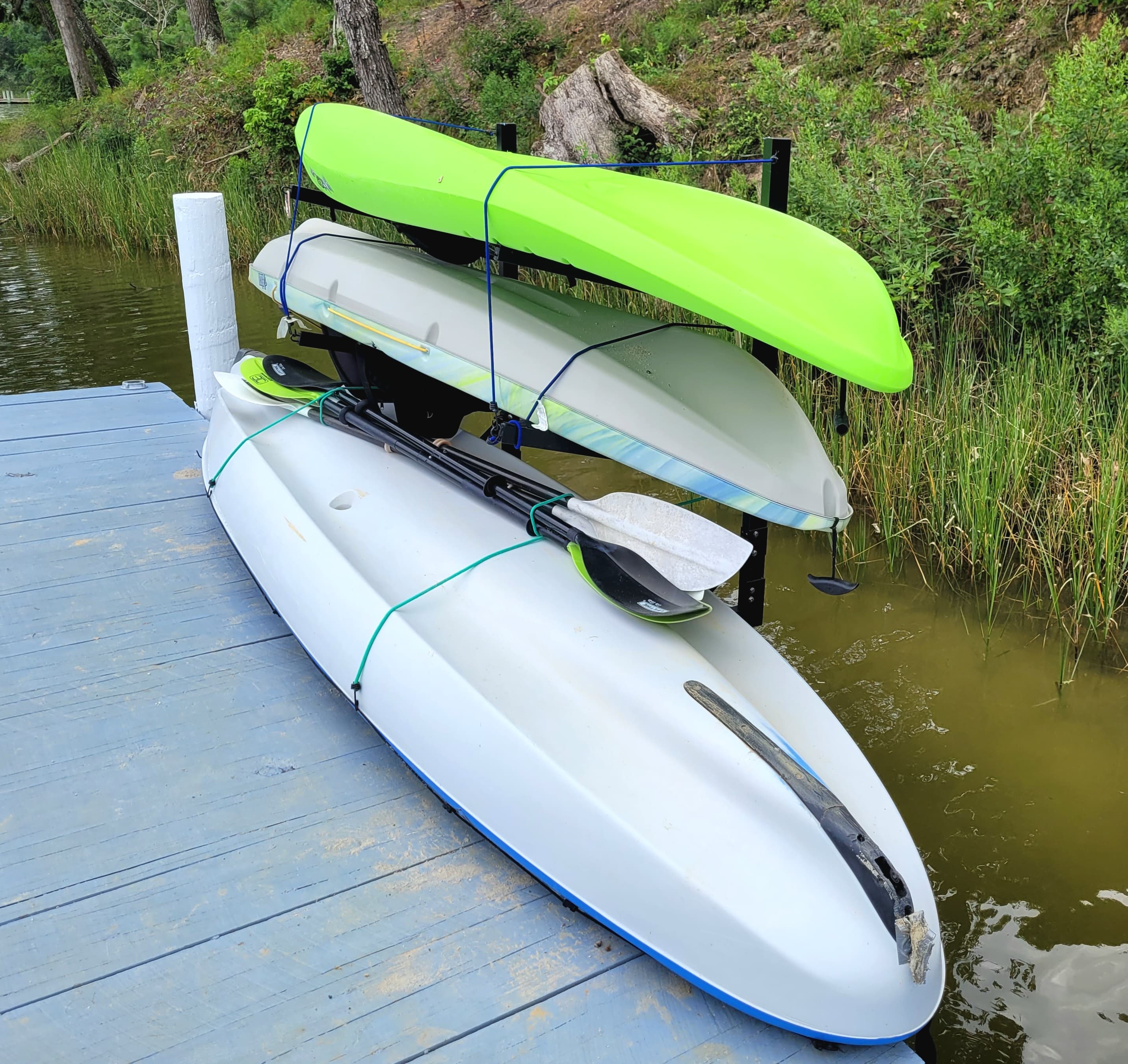 Three of four kayaks on dock. Children’s kayak in shed.