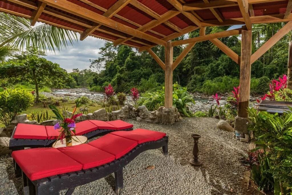 Relax by the river at our Jungle Beach Vacation Nature Lodge