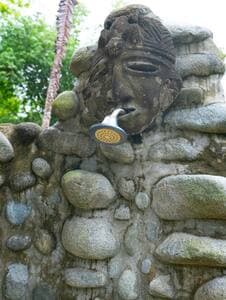 The shower pool is handcrafted with river rocks.  
