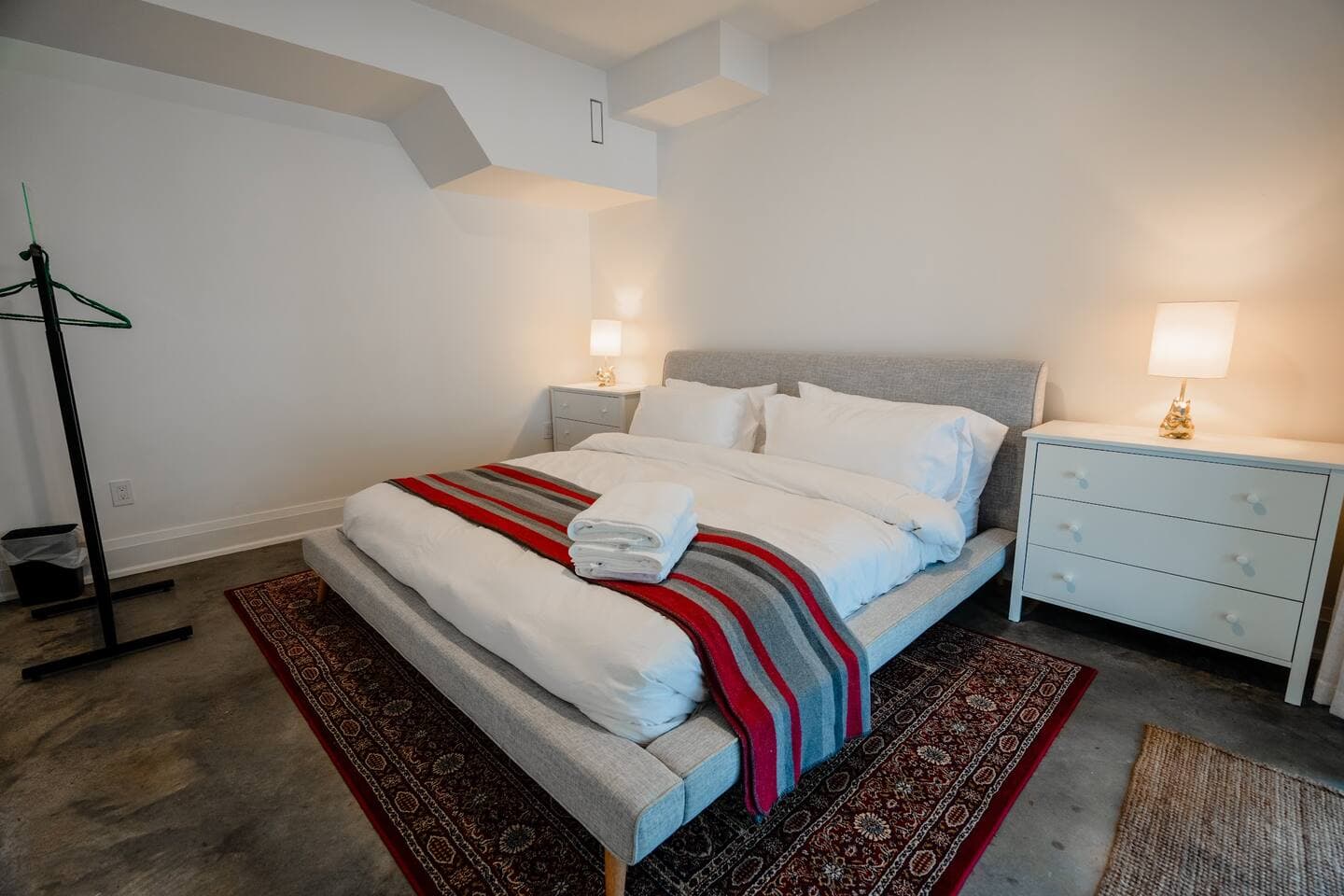 King sized bed in the basement in walk-out basement with its own dedicated patio doors.