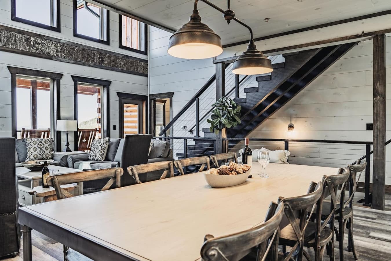 Large dining table as well as two sets of stairs to go upstairs or downstairs