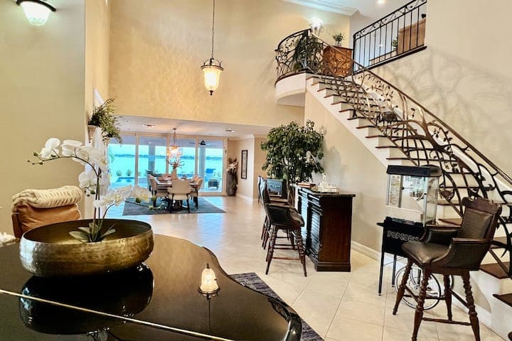 Home entrance. 22 foot ceiling Grand staircase and large dining room overlooking the water