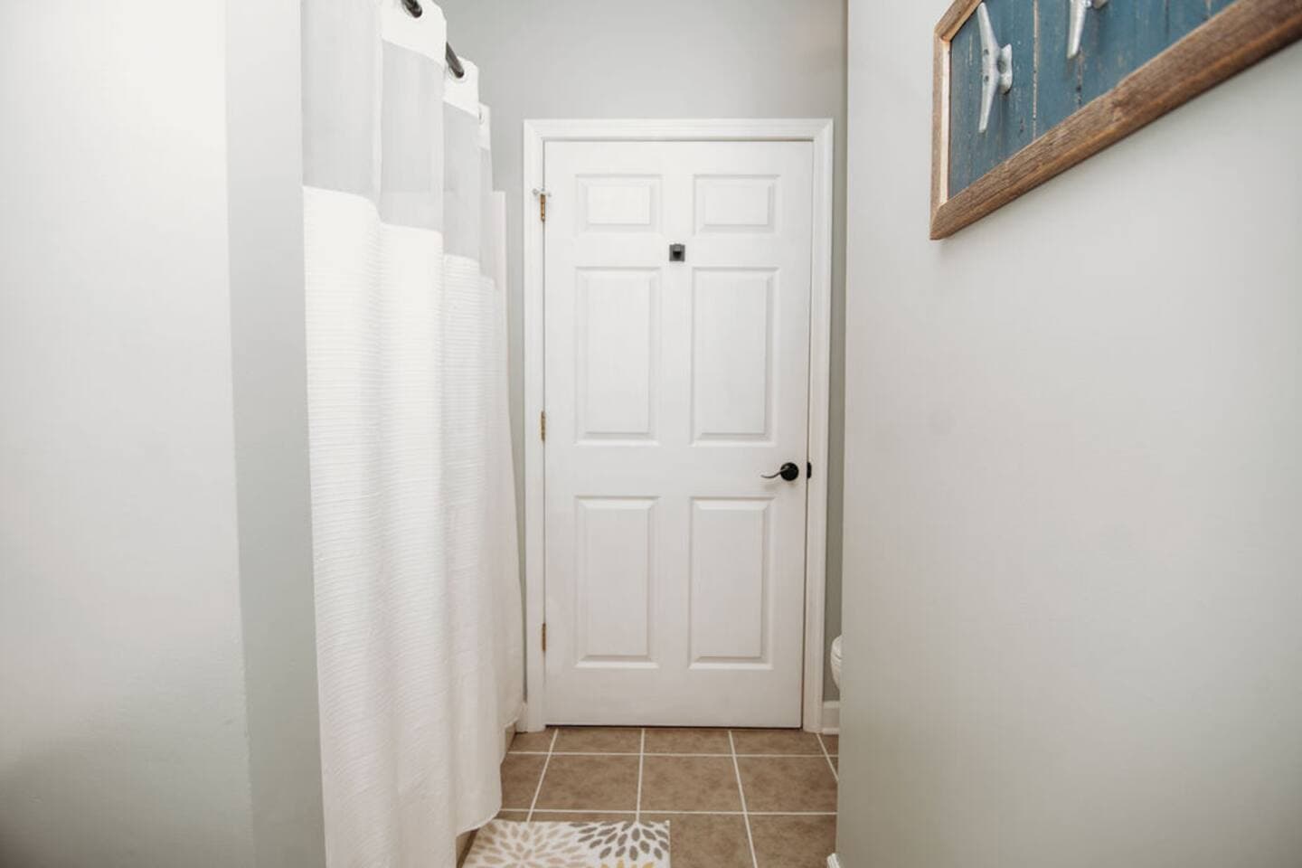 This full bathroom includes a spacious shower with an extended curved shower rod, offering extra elbow room and comfort. Clean lines and soft tones create a relaxing, spa-like atmosphere. Includes shampoo, conditioner and body wash.

