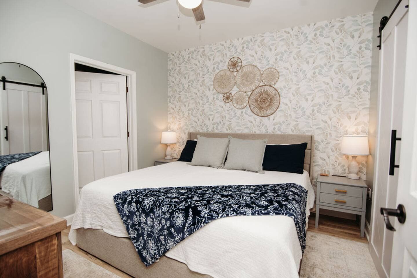 Relax in this serene bedroom featuring a plush king-size bed, calming neutral tones, stylish decor, and ample lighting—your perfect retreat after a day of exploring.

