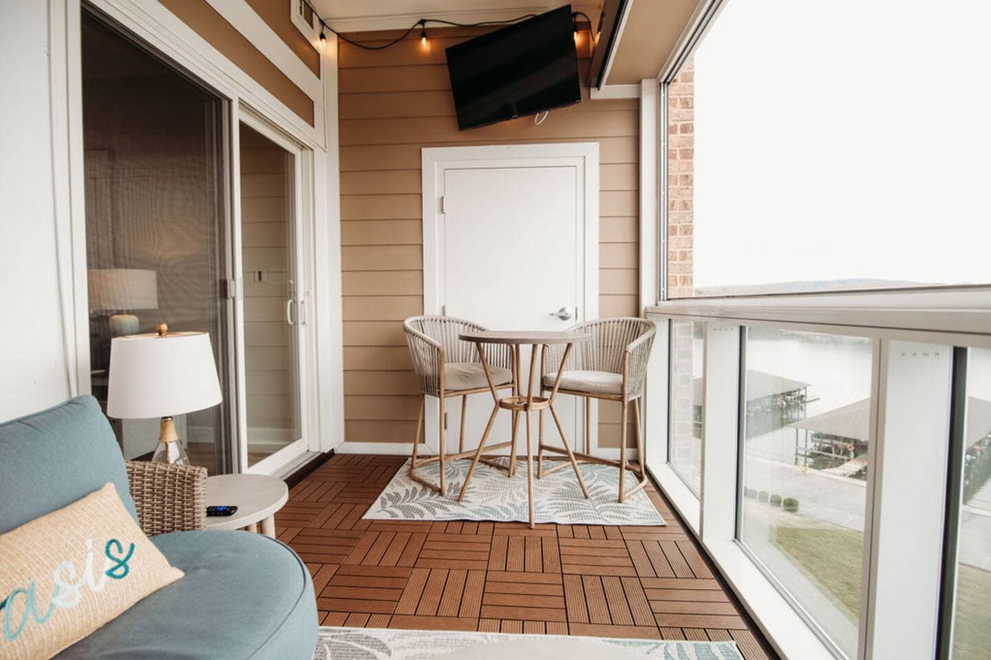 Unwind on the stylish balcony with a mounted TV, high-top seating, and stunning lake views—perfect for al fresco dining or catching a game while enjoying the fresh mountain air.

