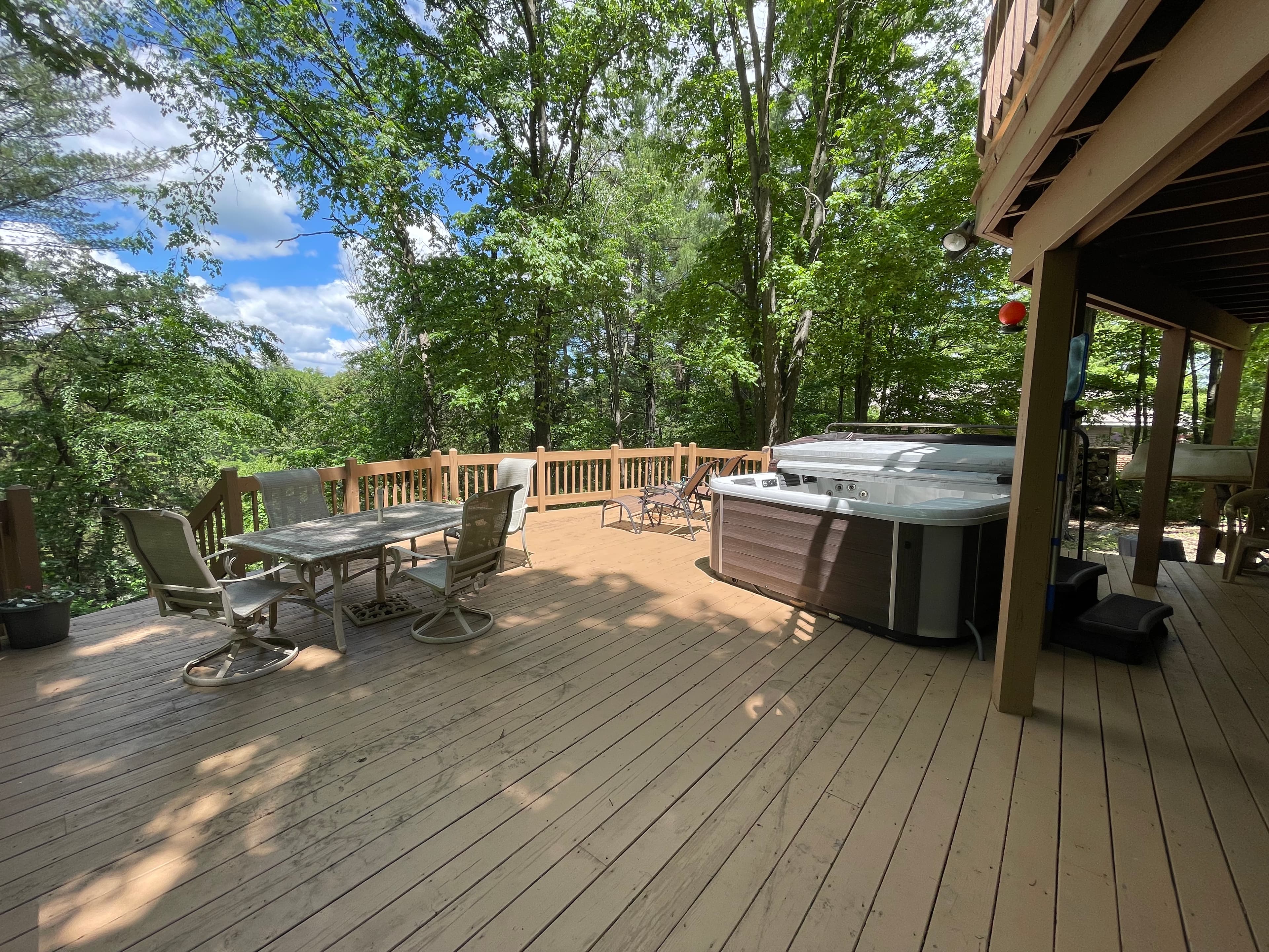 Lower deck with hot tub and outdoor seating. 