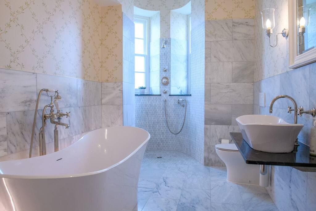 Bedroom 1: Bushta - bathroom with large bath and shower in the turret