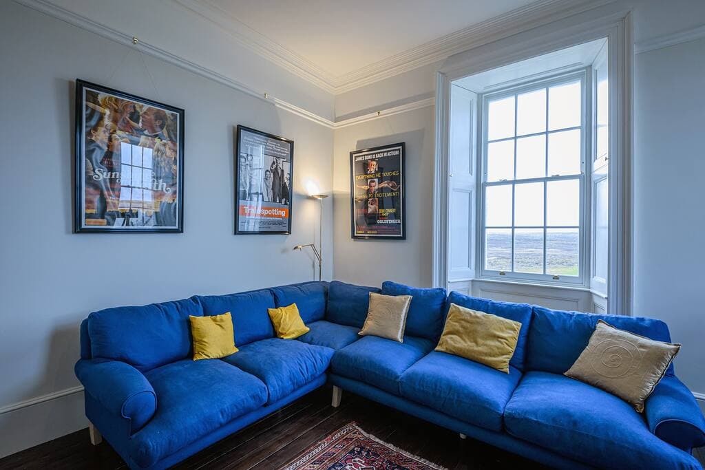 The TV/Cinema room is decorated with film posters featuring famous Scottish actors