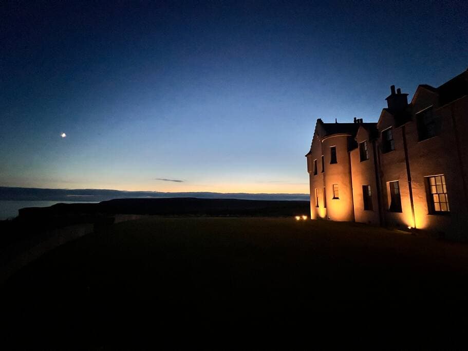 The house at night - in the summer, there is still light in the sky past midnight