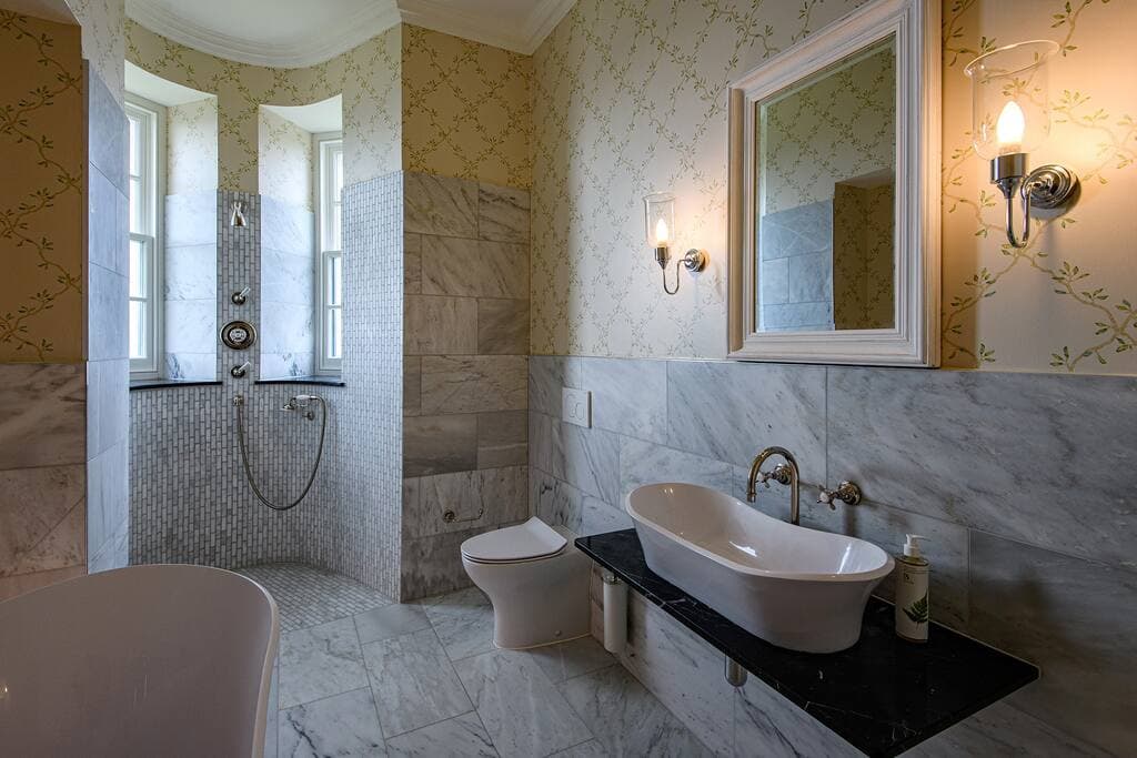 Bedroom 1: Bushta - bathroom with large bath and shower in the turret