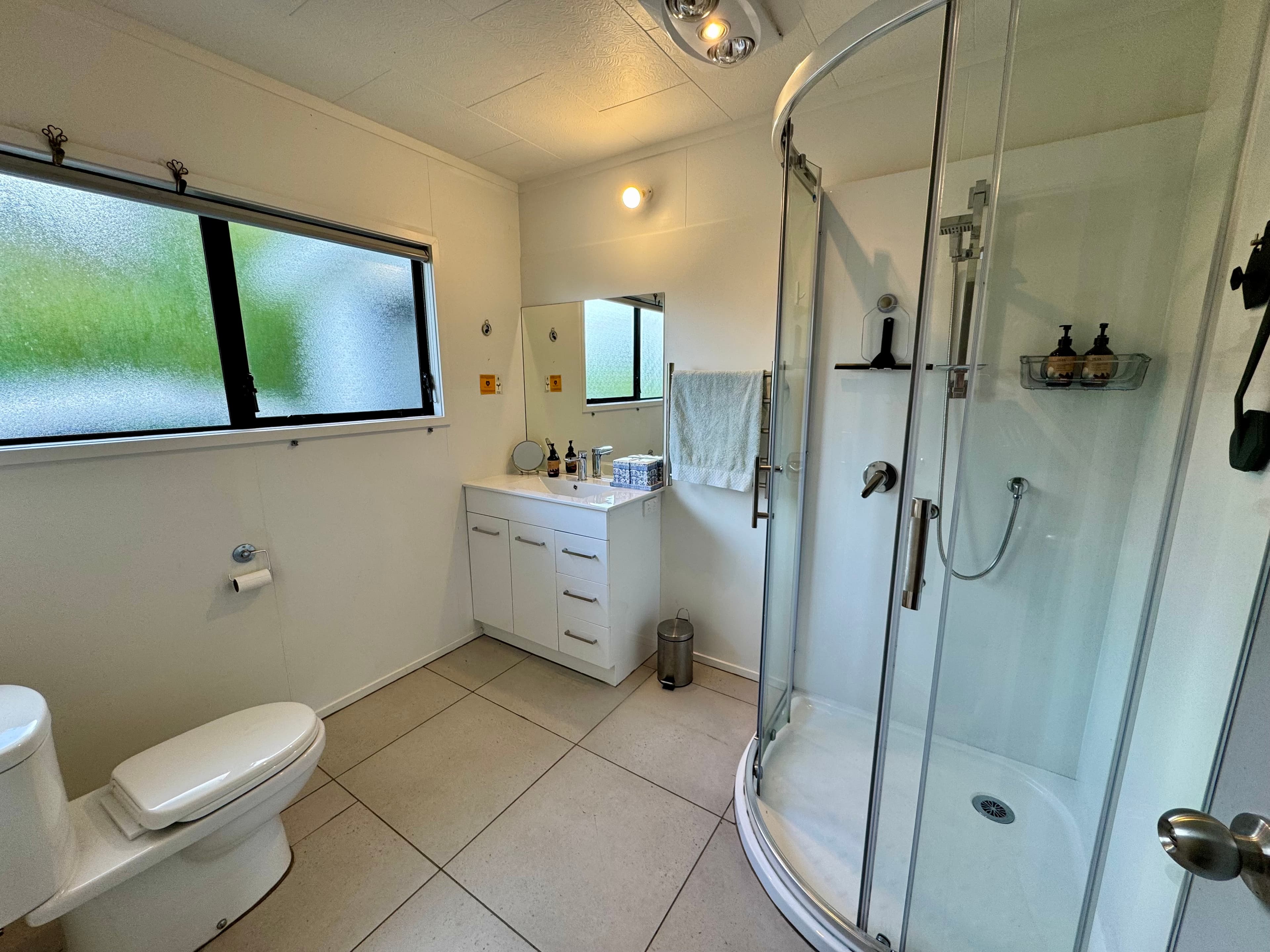 Main Bathroom Featuring premium Huia amenities—supporting NZ Forest & Bird with every stay.