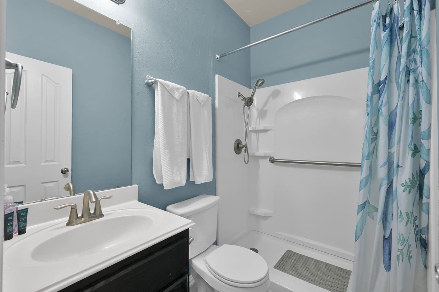 This is the guest bathroom. Wheelchair accessible step-in shower with optional shower chair for loved ones with mobility needs.   Tasteful toiletries provided in each bathroom. 