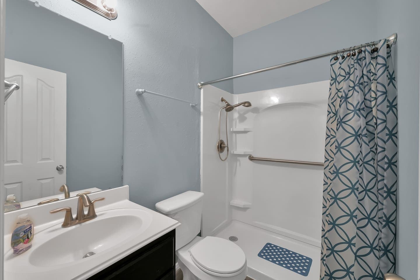Guest bathroom also with accessible step in shower and grab bars