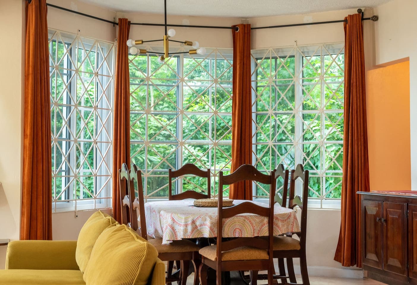 Spacious dining room with beautiful bay windows overlooking the rainforest next door