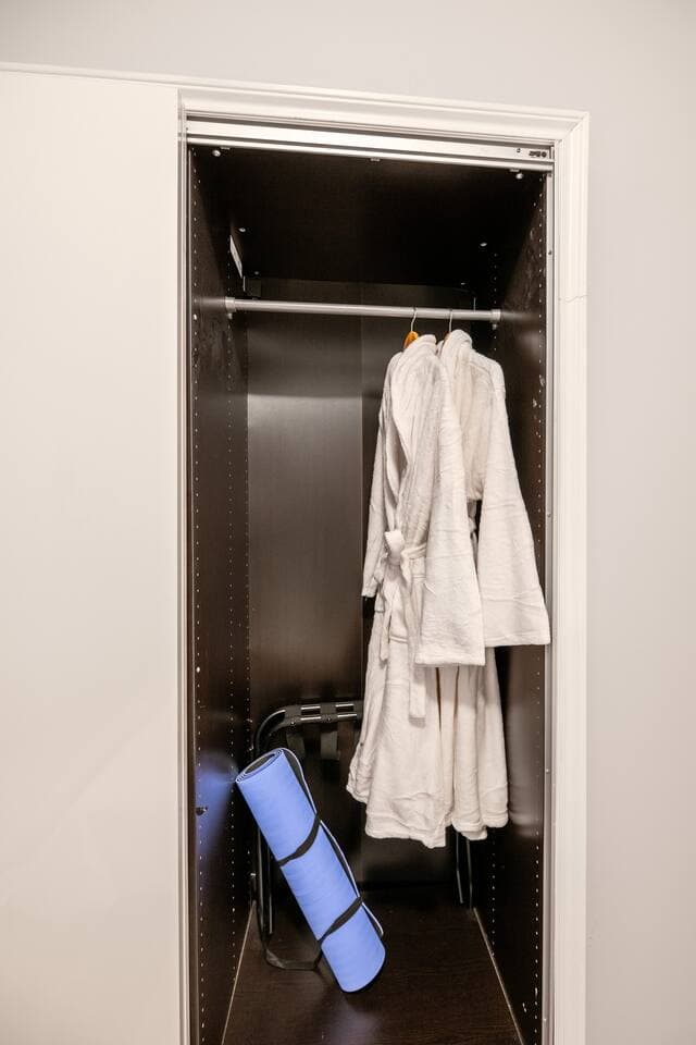 A thoughtfully designed double closet offers both drawer space and a full hanging section with plenty of hangers. Plush robes are included for your stay — and children’s robes are available through our concierge team for family visits.