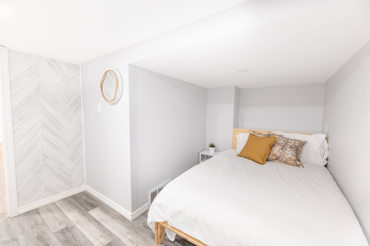 This spacious lower-level bedroom includes a comfortable double bed with fresh linens and sits steps away from the second bathroom and additional daybed area — a great setup for families, couples, or groups needing separate sleeping zones