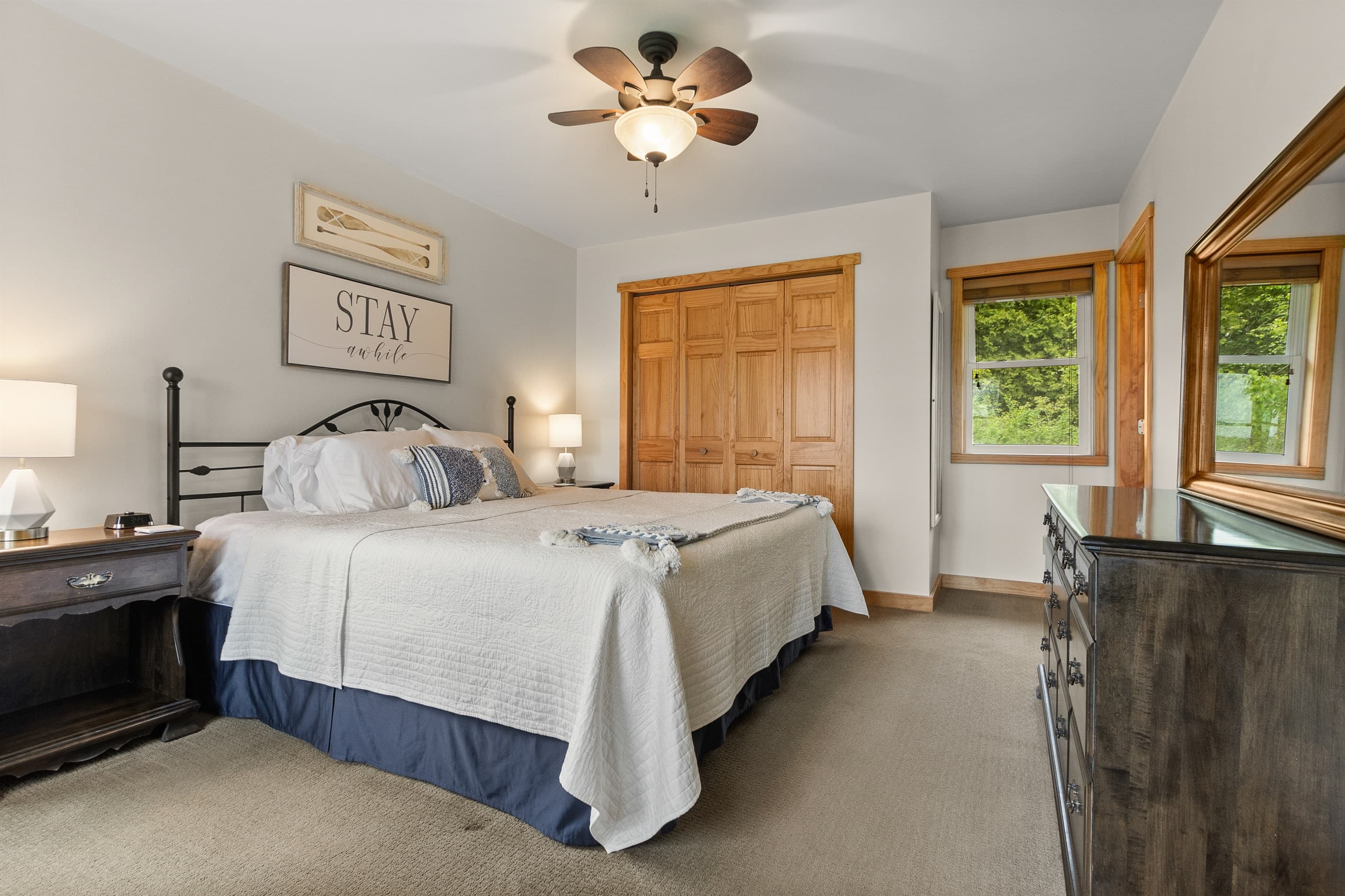 The main floor king bedroom is where the sign above the bed says 'Stay Awhile' — and for once, you might actually take the advice. Quiet, private, and the first real sleep you've had in weeks.