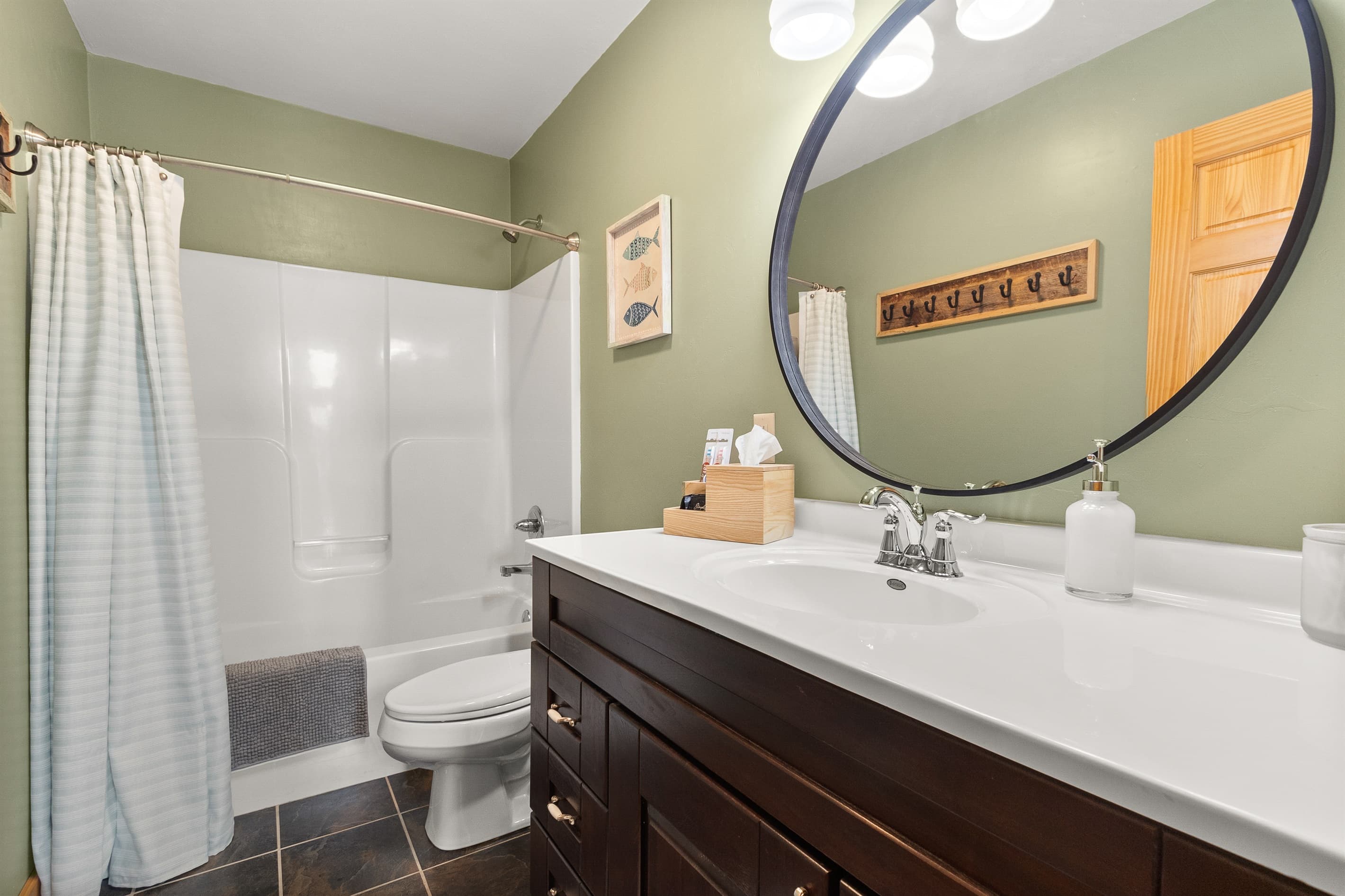 Two bathrooms means the whole group isn't rotating through one shower. The second bath has a tub/shower combo and the same curated amenities — no second-class bathrooms at Sawyer Harbor Retreat.
