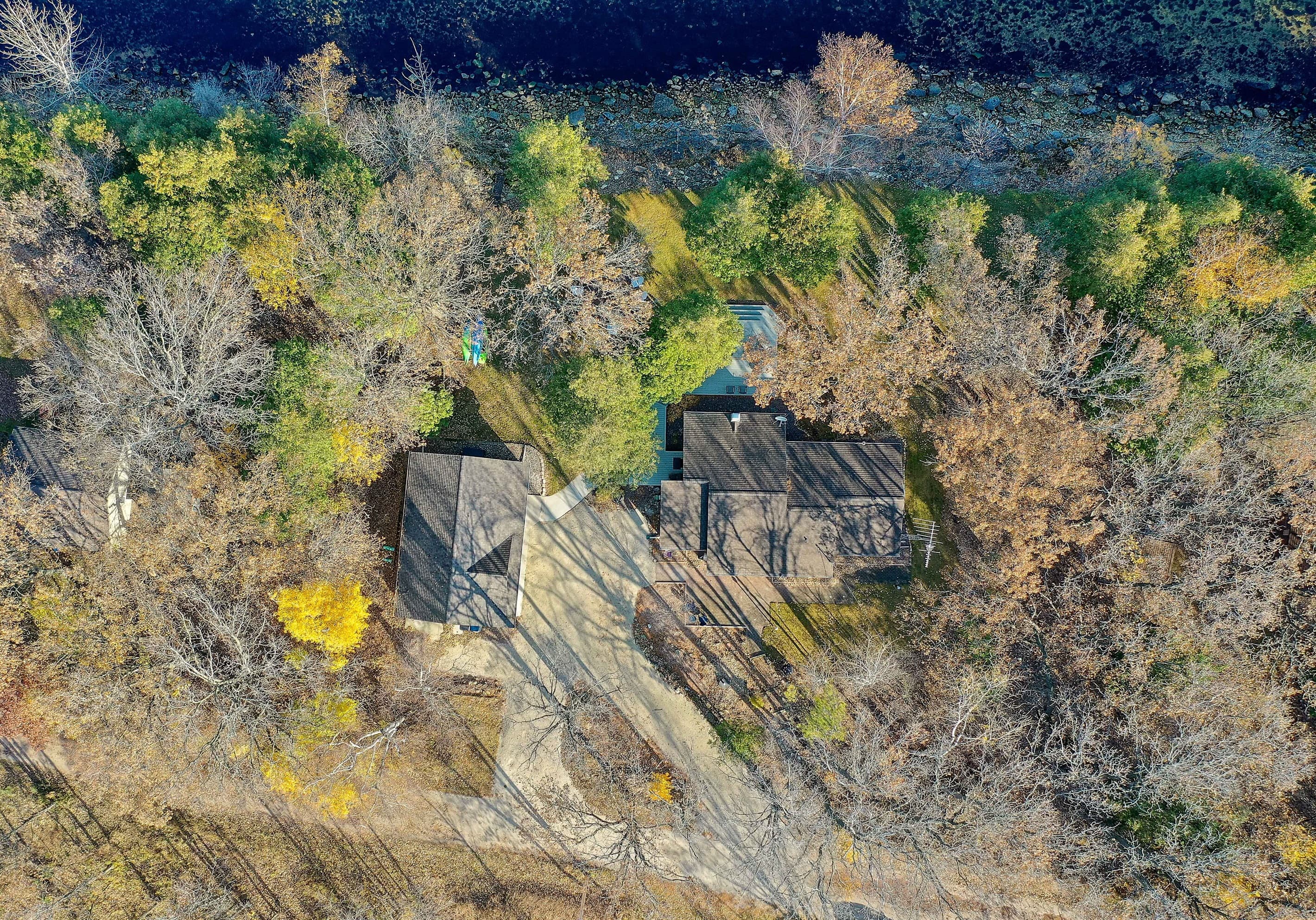 Two structures, 180 feet of private shoreline, and nothing but trees and water between you and the open bay. This is what a true Door County retreat looks like from above.