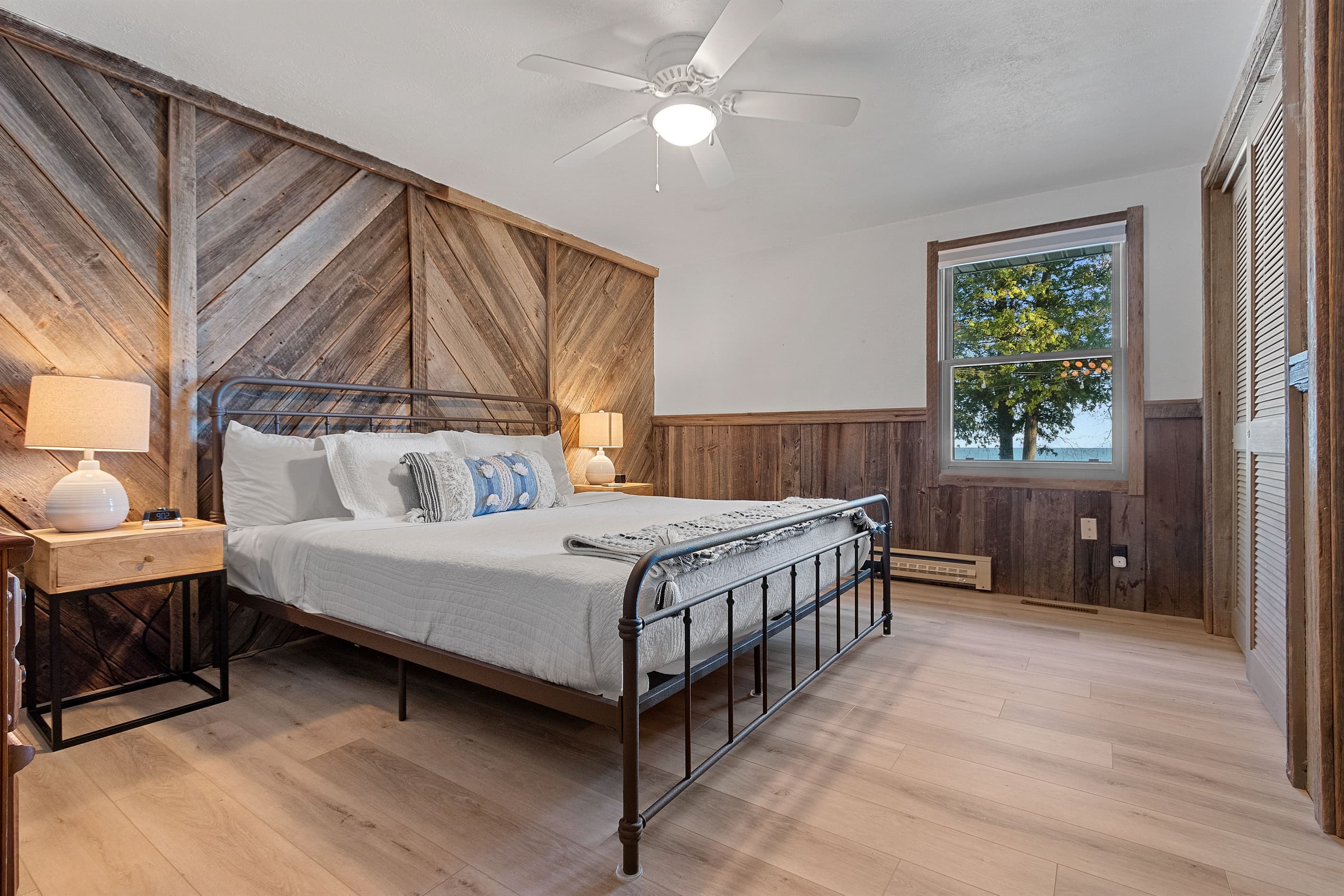 The master bedroom has a king bed and water views. You can wake up feeling refreshed after sleeping in this cozy space with fresh linens! With device chargers by your side, you'll be ready to