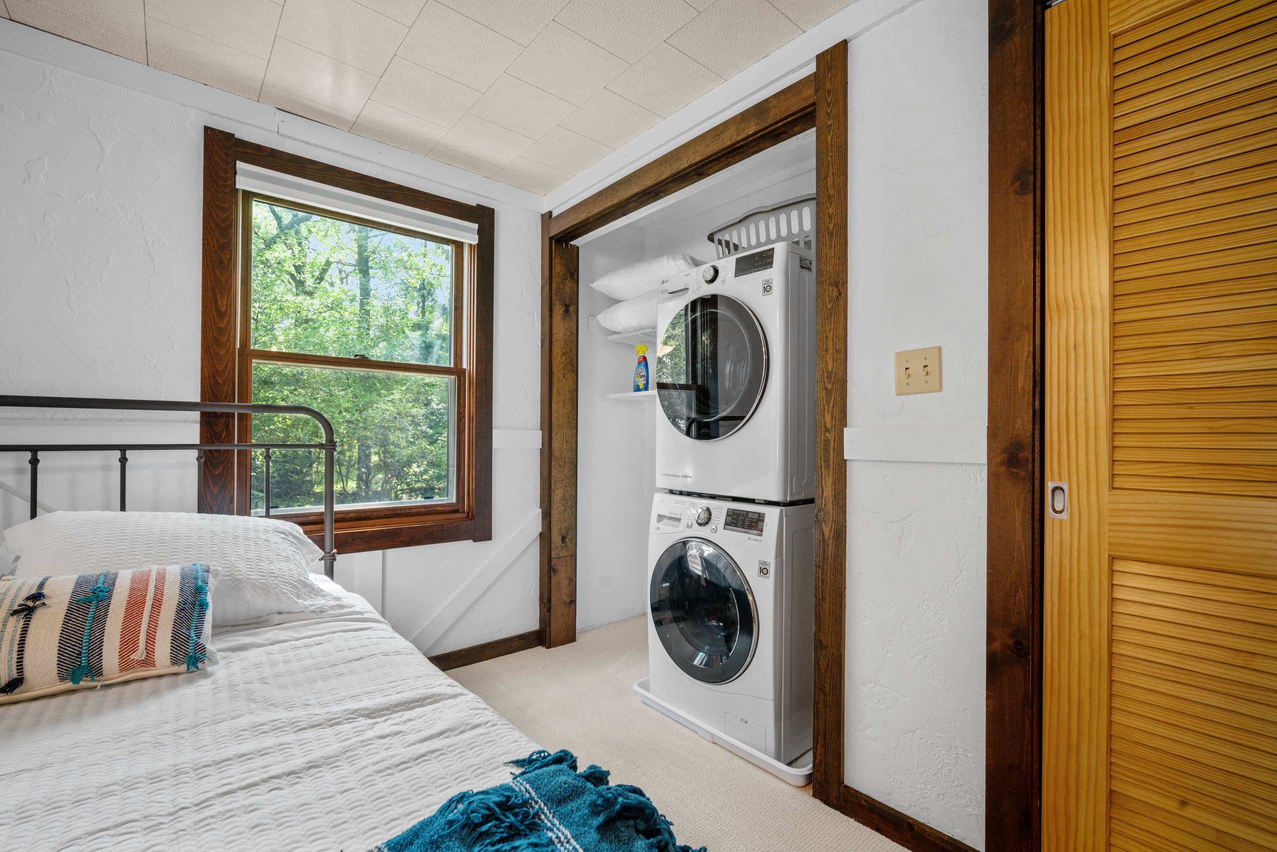 Everything you need for a longer stay: a full-size LG stacked set, shelving for supplies, and hangers already on the rod. Packing lighter was actually an option here.