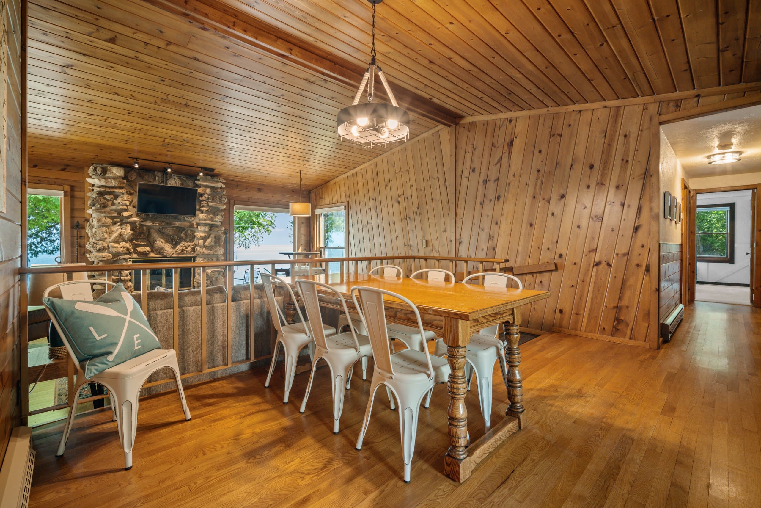 The farmhouse table fits eight comfortably, the bay is right outside the window, and dinner conversations here tend to go later than planned. That's the point.