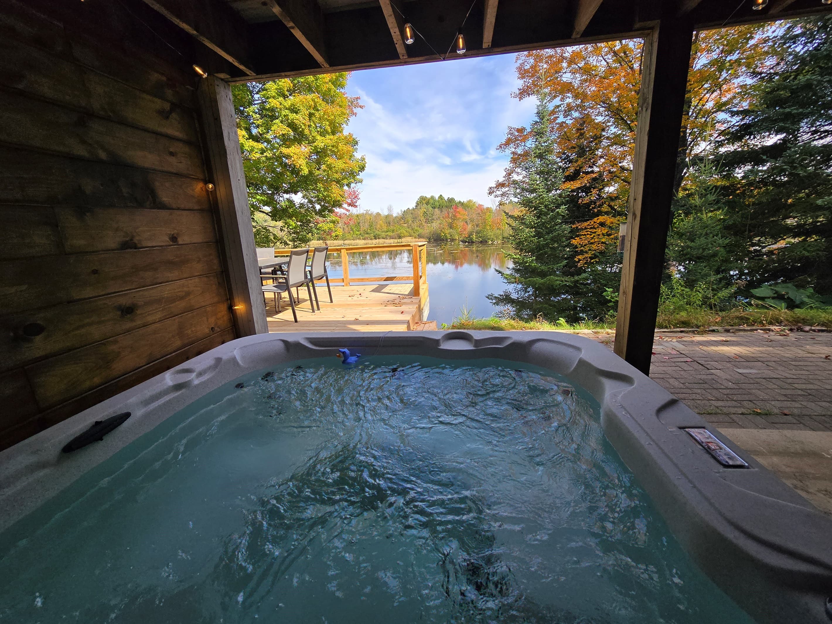 - unwind in the private hot tub with lake scenery   - covered patio offers shade and year-round comfort   - soak and enjoy peaceful views in total relaxation