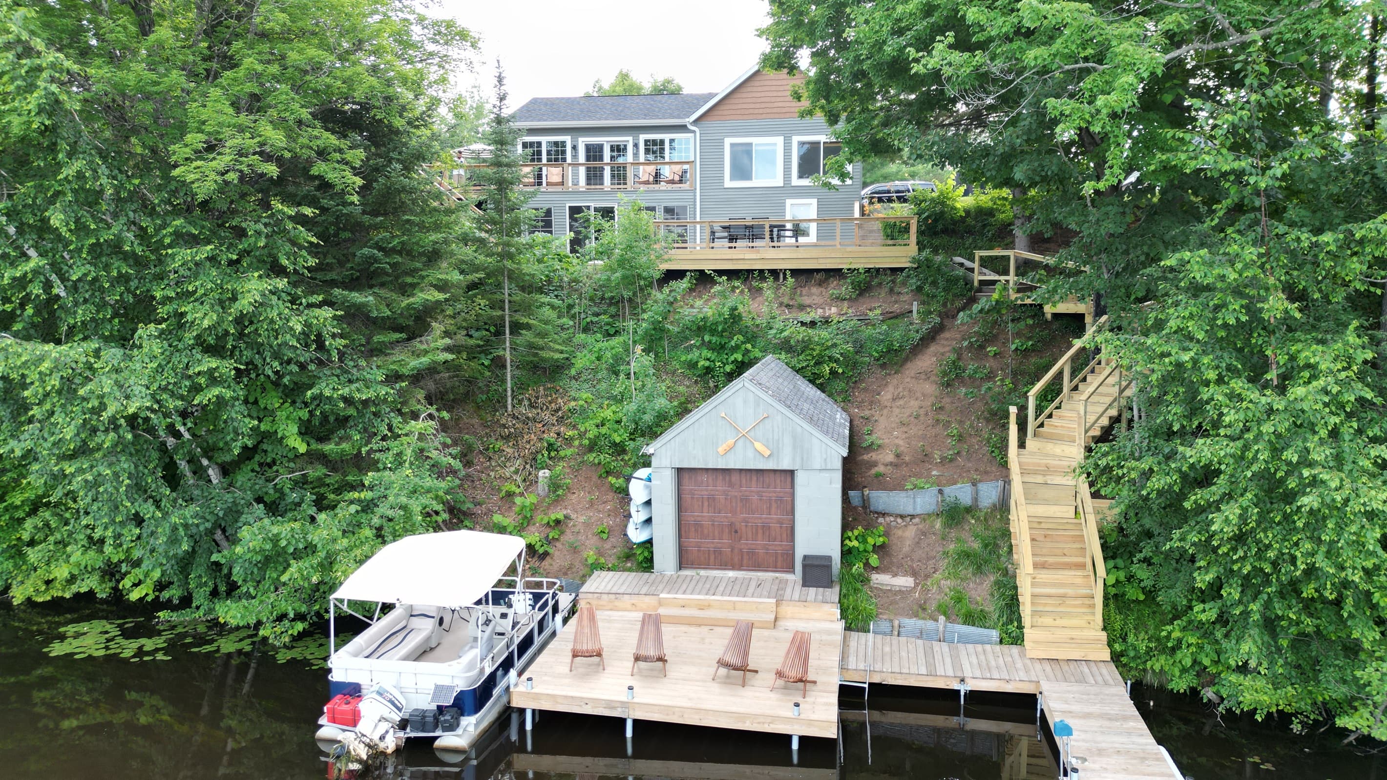 - Lakefront home with multi-level decks and private dock   - Easy access to the pontoon and Adirondack seating   - Scenic hillside layout designed for true lake living