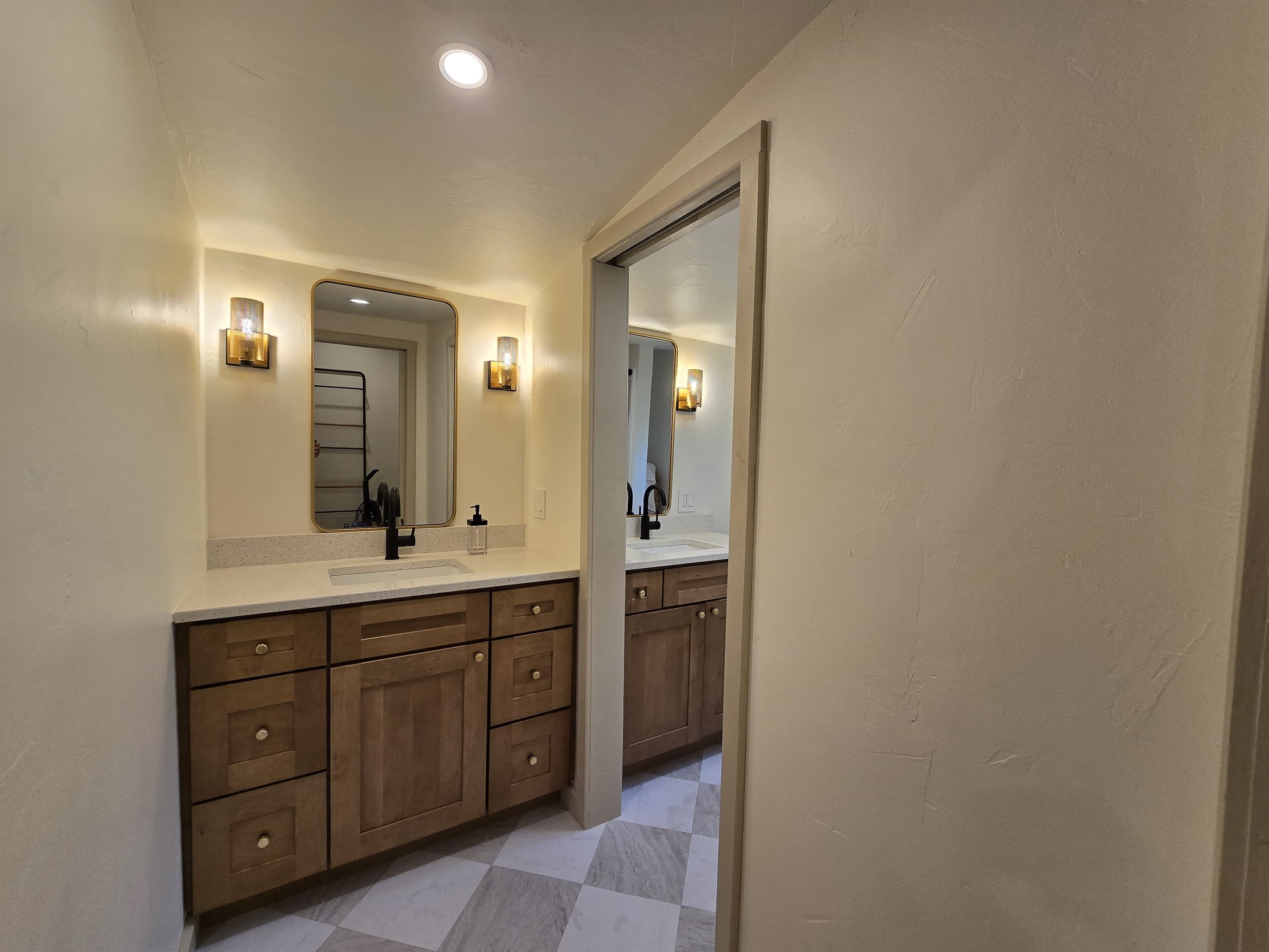 - Updated bathroom with warm lighting and modern vanity   - Spacious counter makes getting ready feel effortless   - Clean bright design perfect for guest comfort