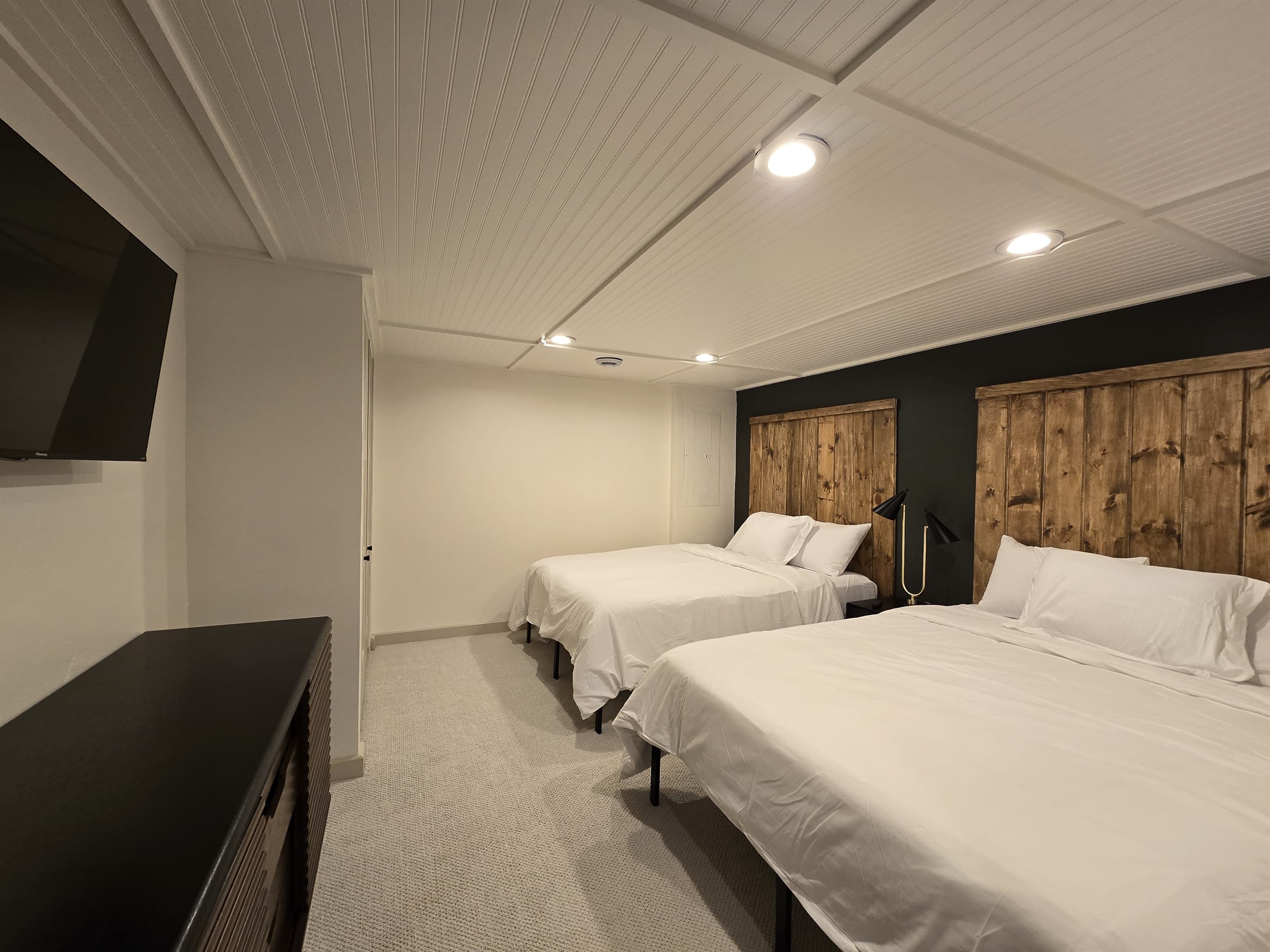 - Spacious room with two comfy beds for group stays   - Wood accents and soft lighting create warm comfort   - Ideal setup for families or friends to unwind together
