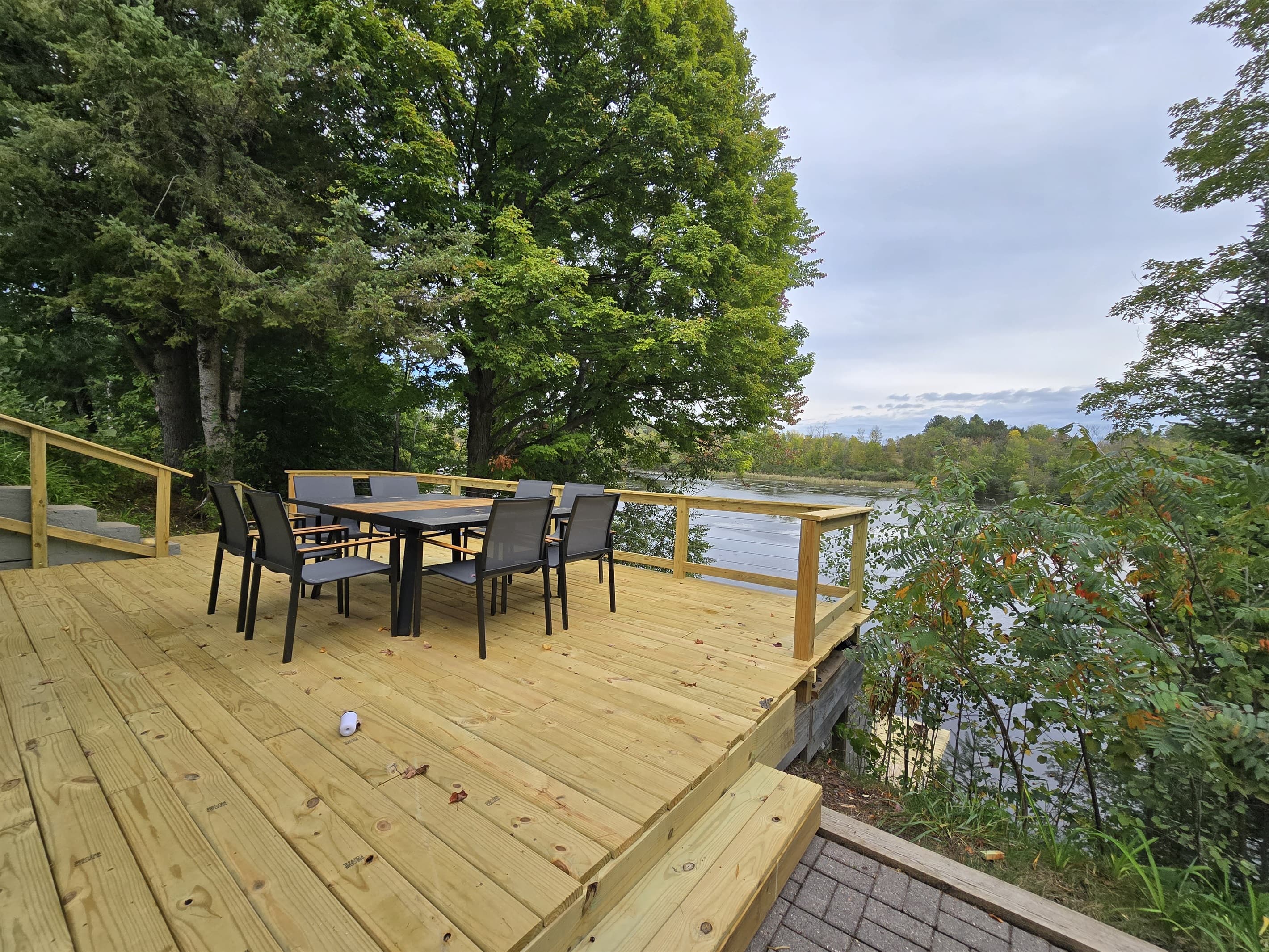 - Outdoor dining deck with peaceful lakeside scenery   - Surrounded by trees for a private relaxing atmosphere   - Perfect spot for meals, gatherings, and lake moments