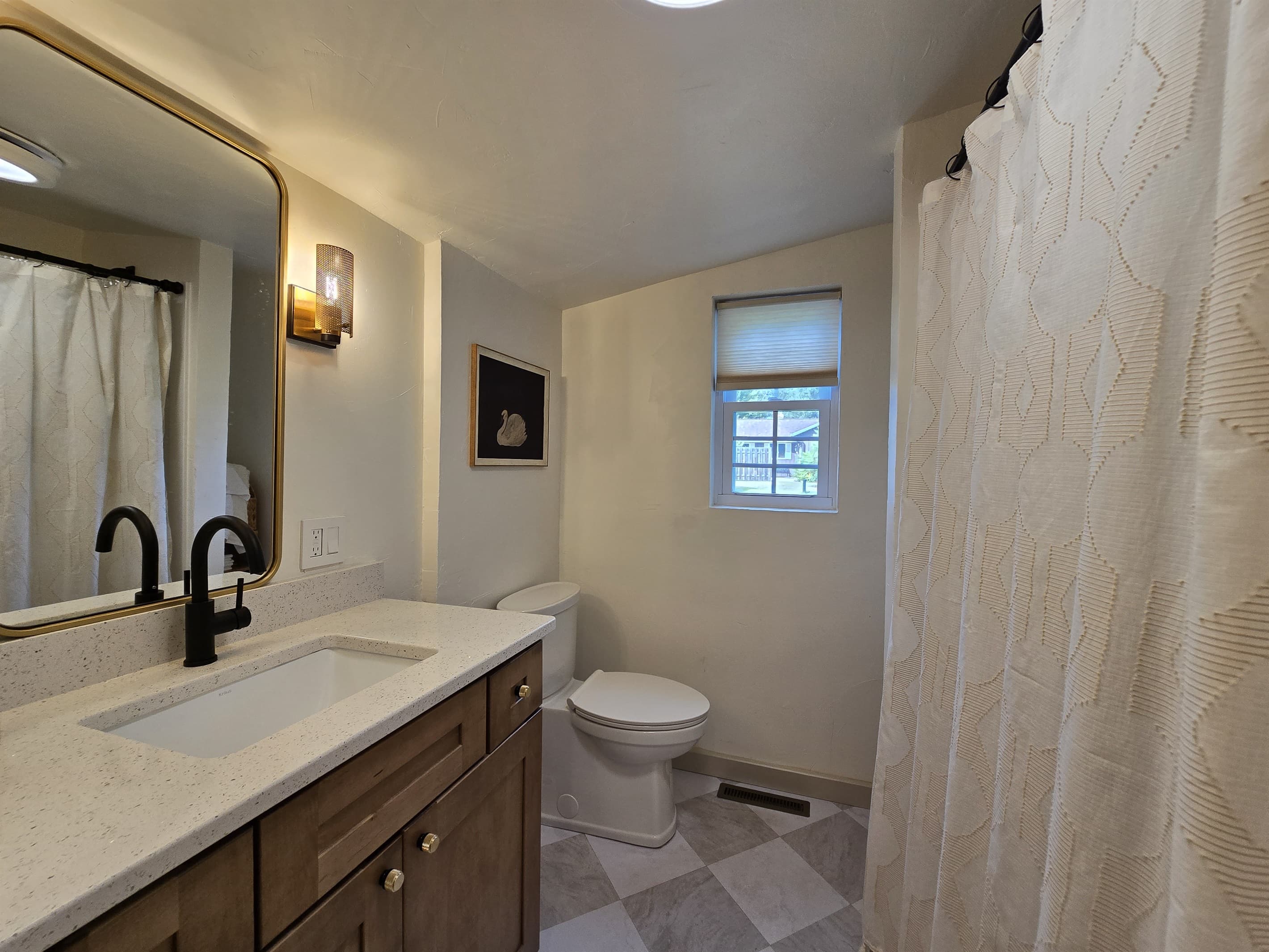 - Modern bathroom with warm lighting and clean finishes   - Spacious vanity and bright design for easy routines   - A fresh comforting space for guests to unwind