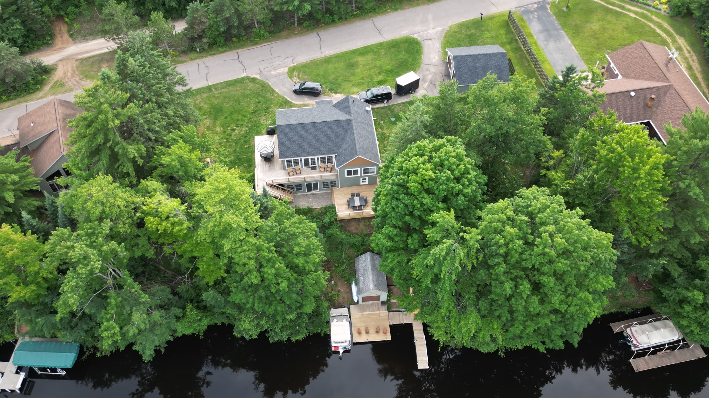 - Aerial view of the home nestled in tall trees   - Multi level decks and private dock by the water   - Perfect layout for lake stays outdoor fun and privacy